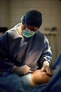 head surgeon and director of Mediburg Clinic Balazs, performs an operation to exchange breast implants of a patient in Szent Istvan Hospital in Budapest, Hungary, 28 February 2012. The operation was performed because the implants used by the patient grew old. EPA/PETER KOLLANYI **HUNGARY OUT**